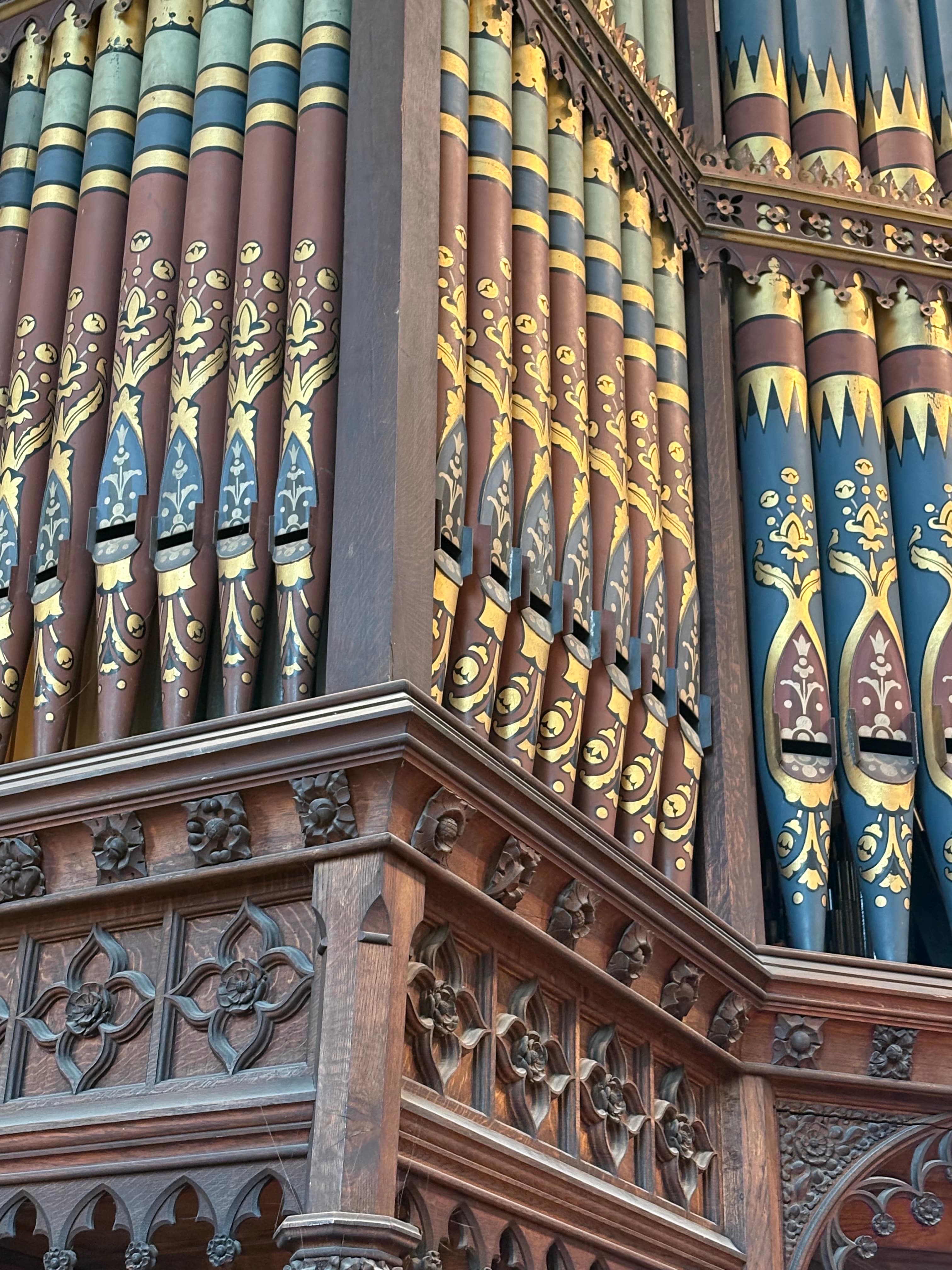 Detail of the painted and gilded organ pipes with the timbered roof above