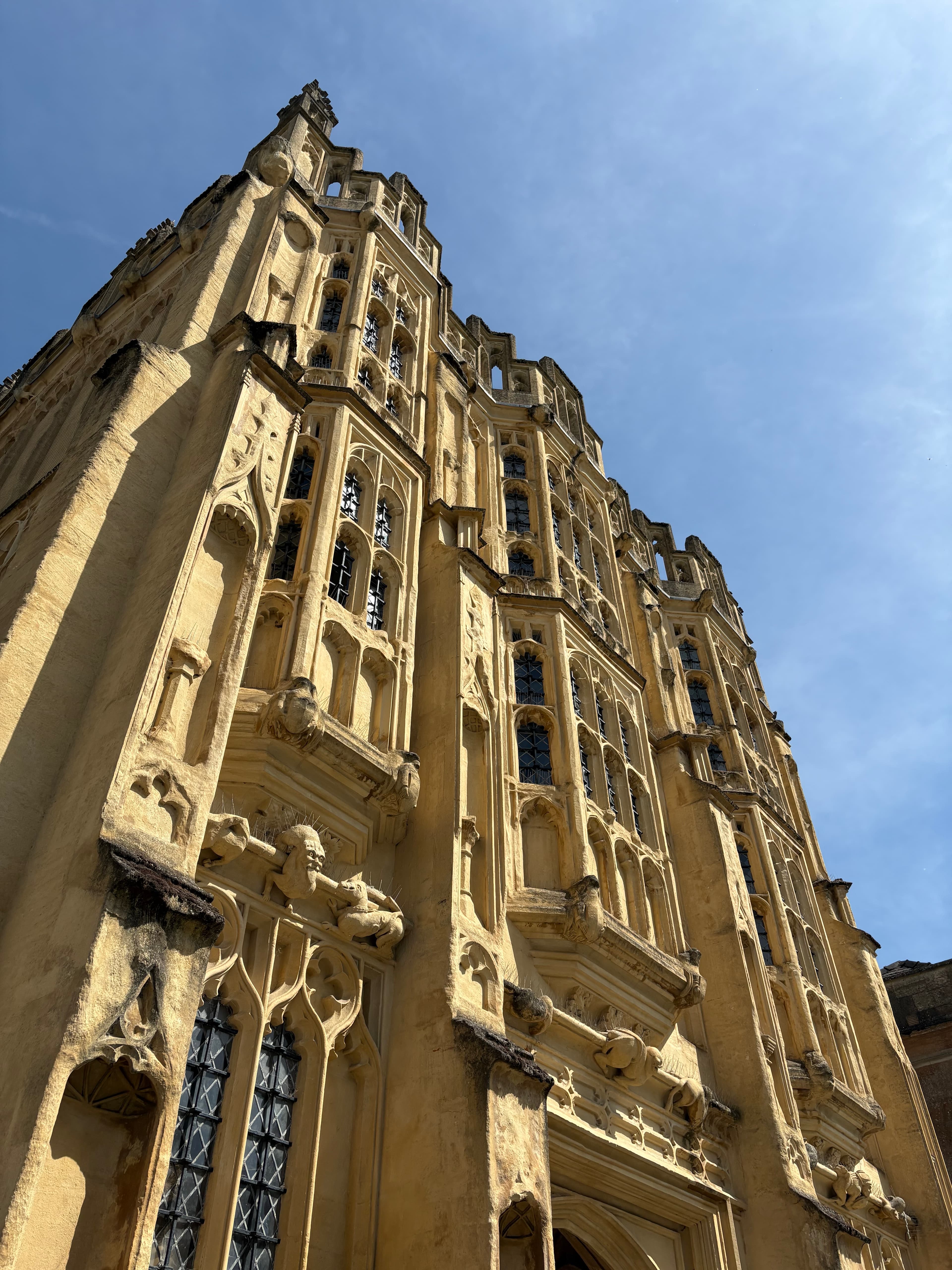 Looking up at the Perpendicular tracery and battlements of the church tower