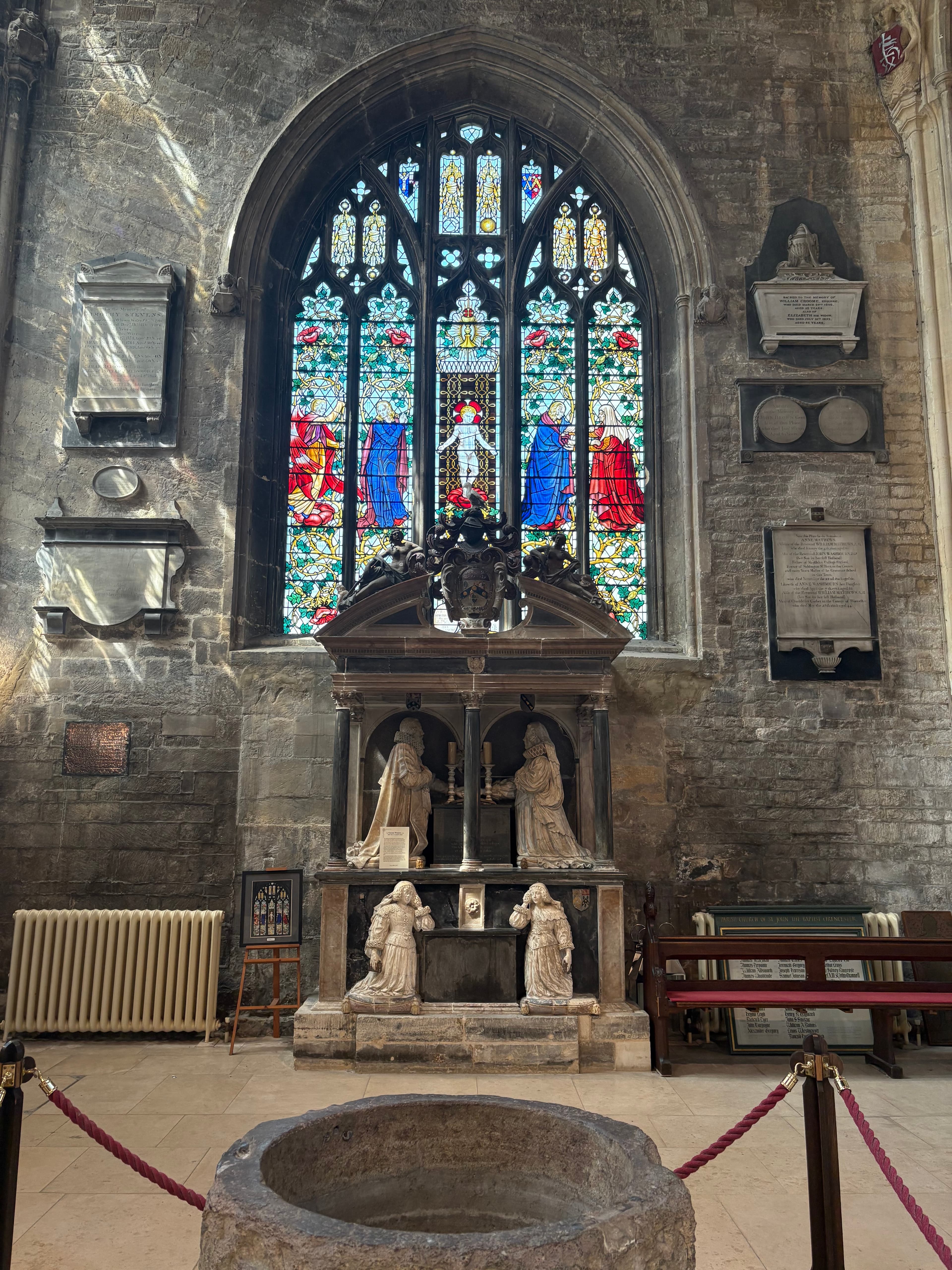 Trinity Chapel interior — stained glass above carved stone tombs