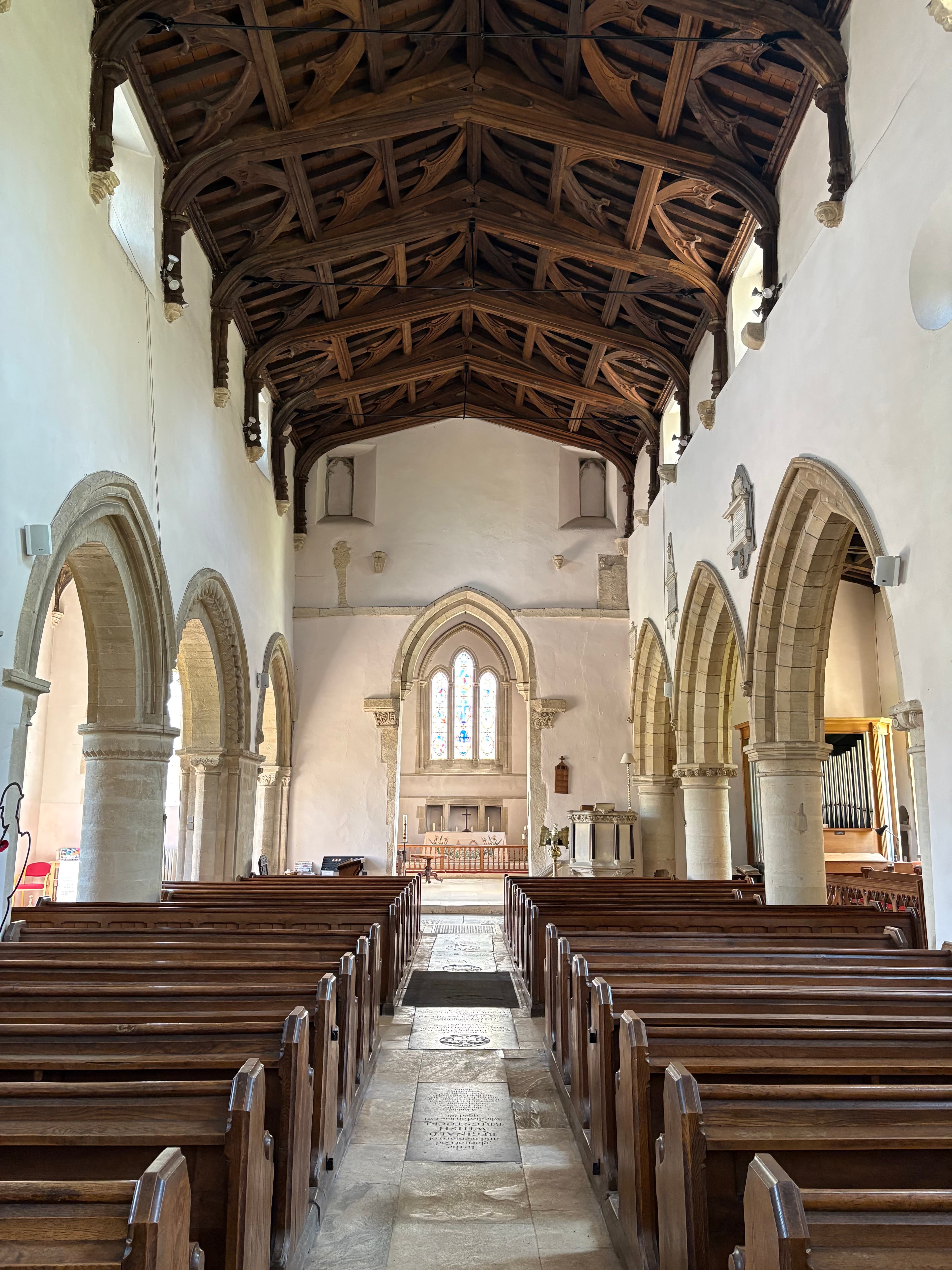 Looking up the nave at St Mary's — timbered roof, pale stone arches and the chancel beyond