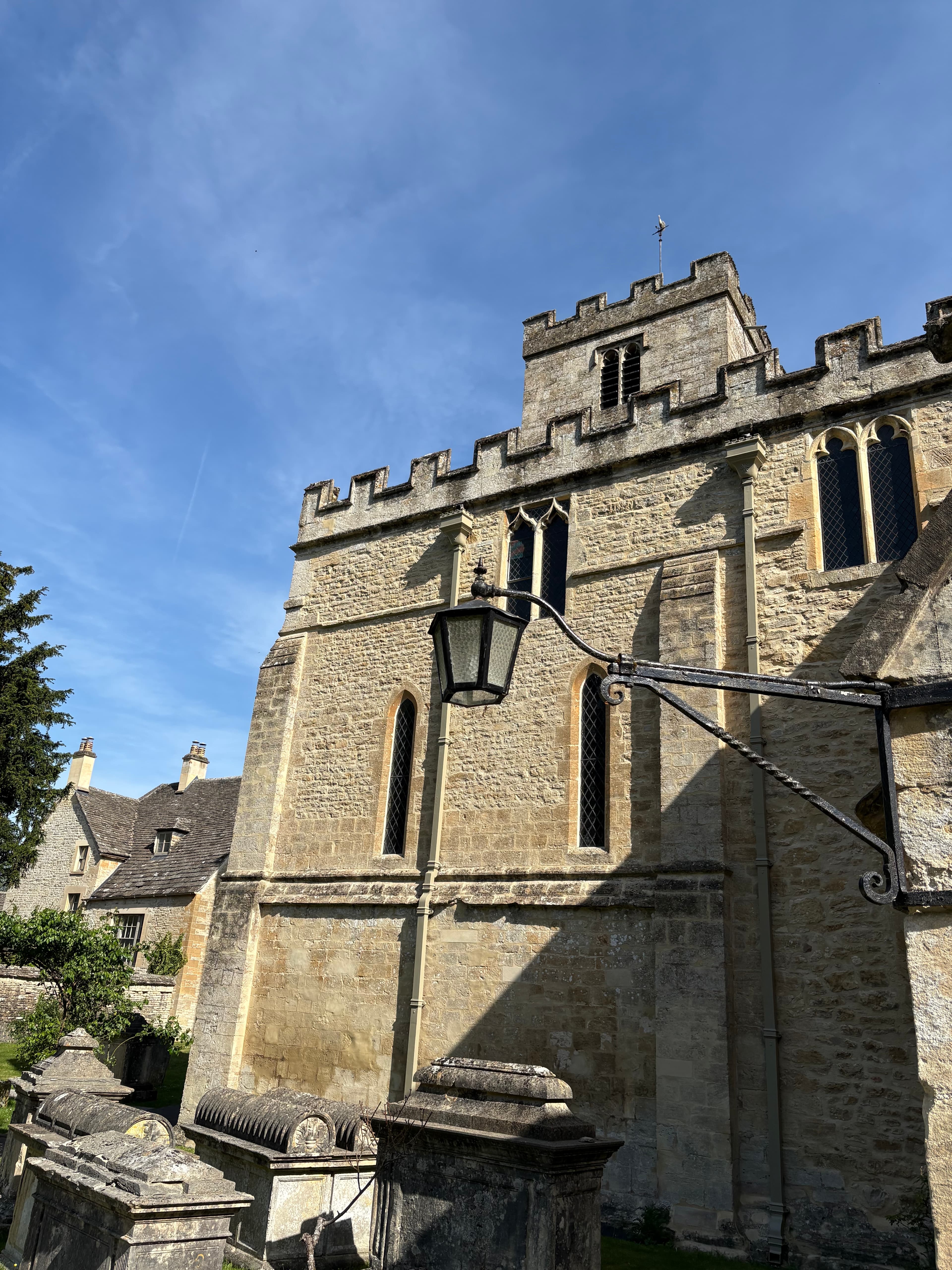The tower wall of St Mary's with an iron lamp bracket and lantern