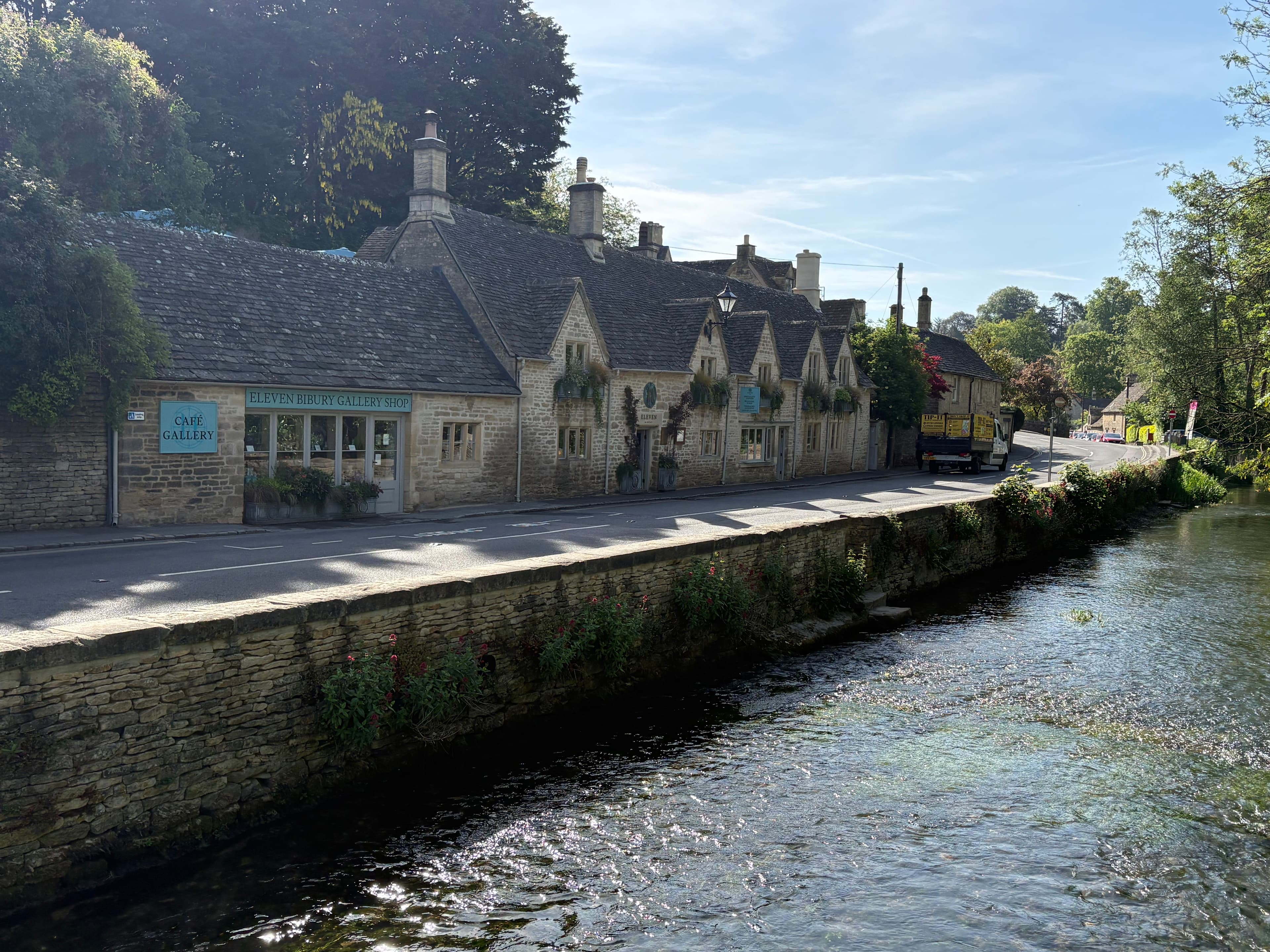 The Galleries — a row of stone shops alongside the River Coln in Bibury