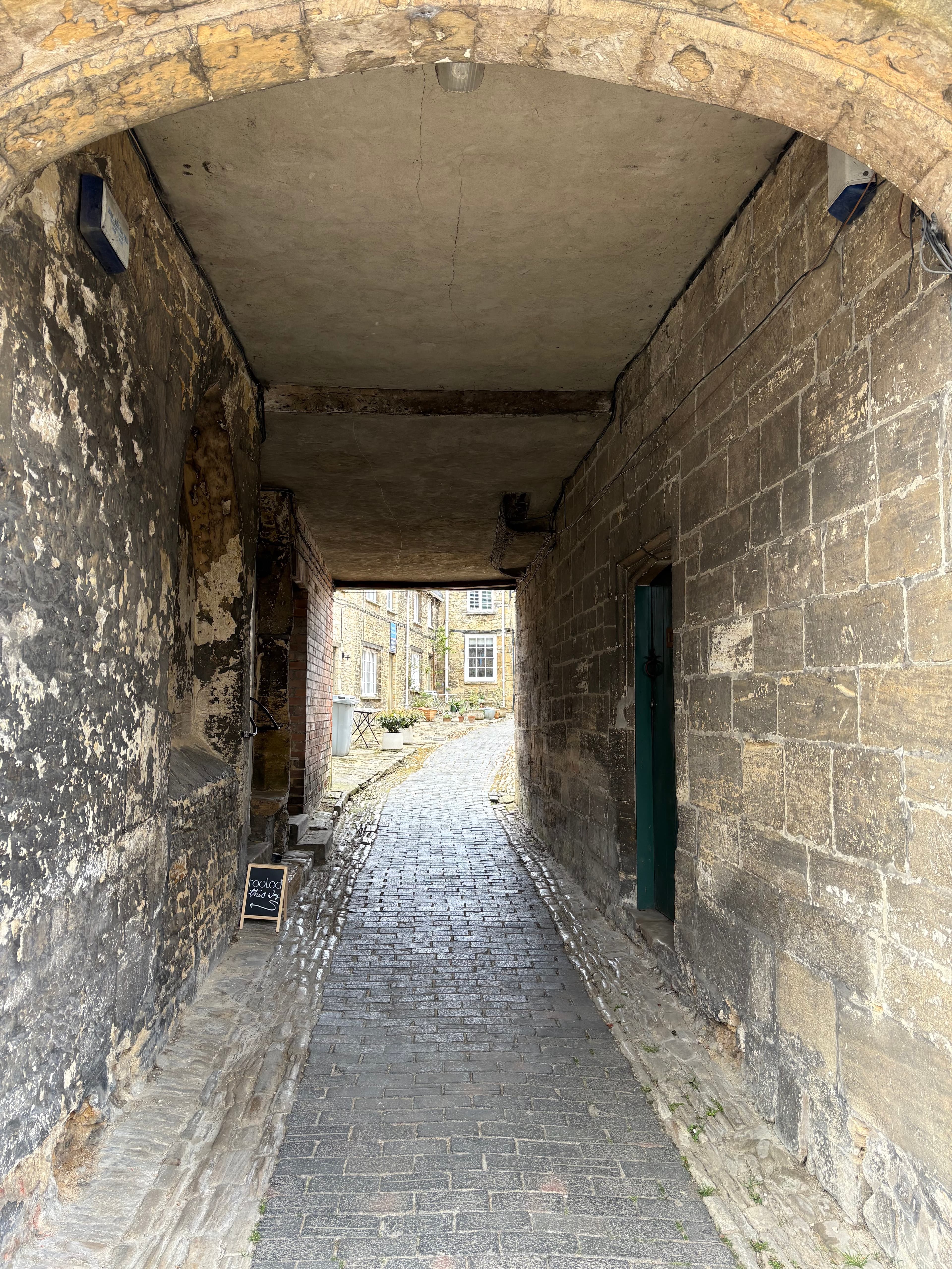 An arched stone passage through one of the older houses on the high street