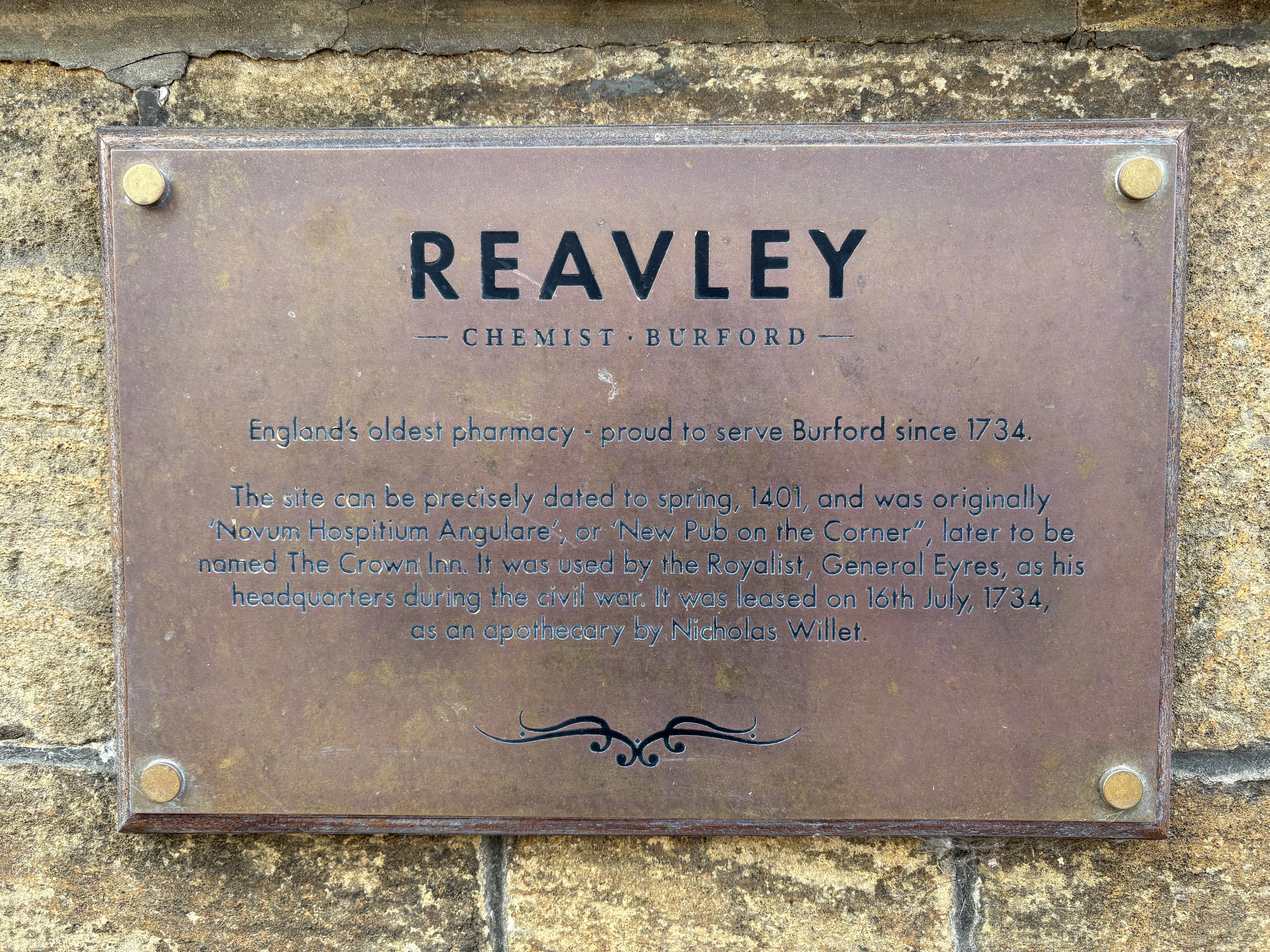 Plaque on Reavley Chemist, England's oldest pharmacy — trading on this site since 1734