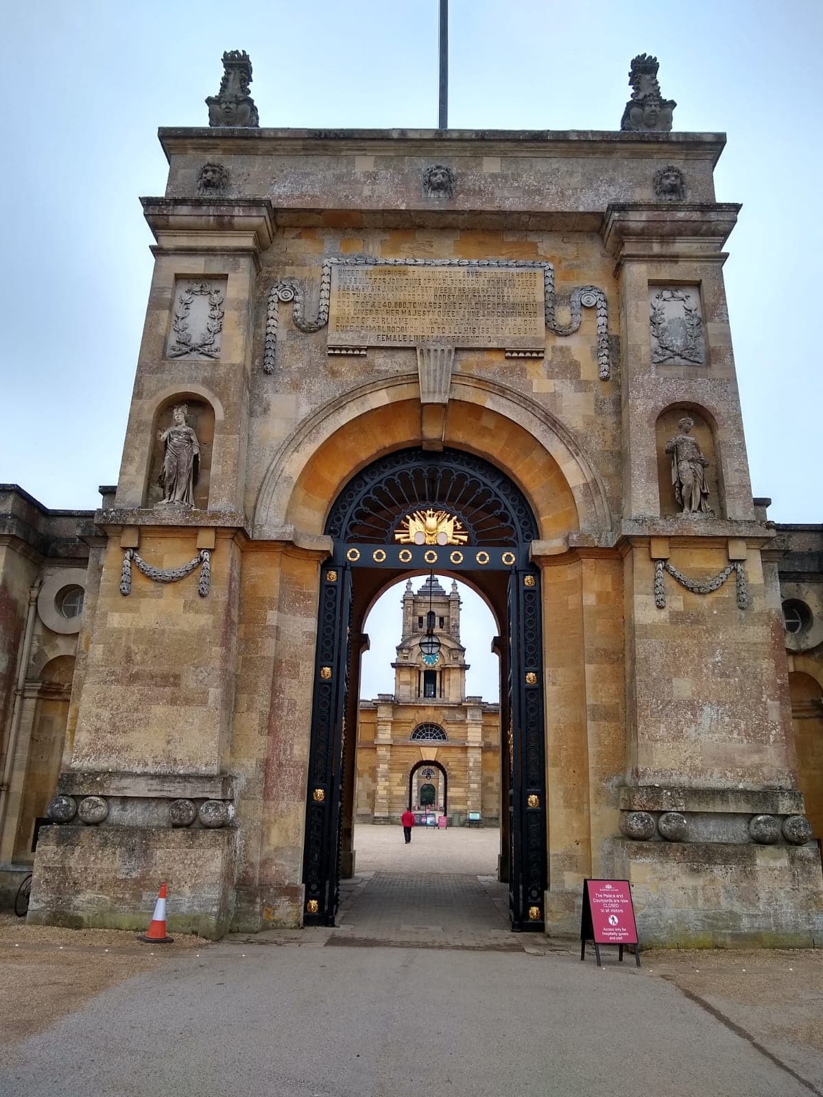 Looking through one of Blenheim's triumphal arches into the Great Court, with the palace's clock tower visible beyond