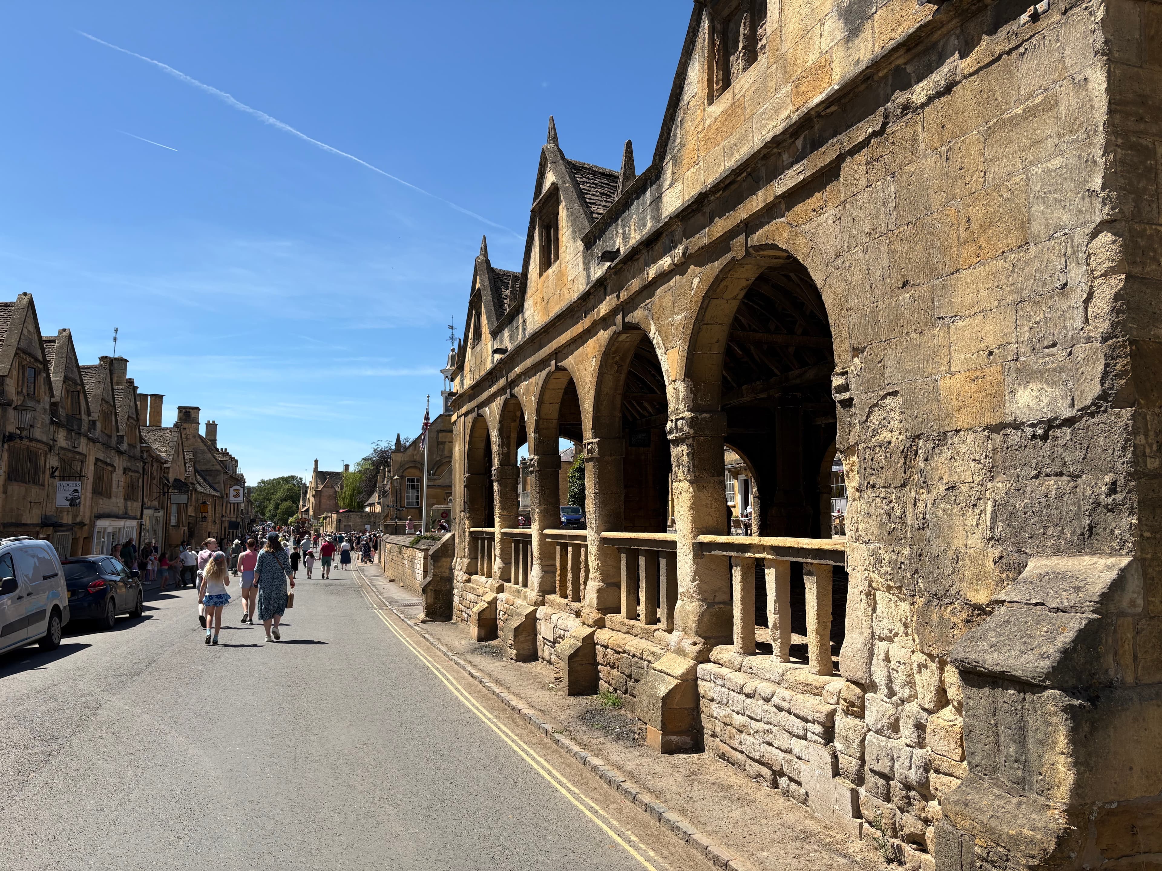 The Market Hall seen down the High Street — gabled roof and a long line of stone arches