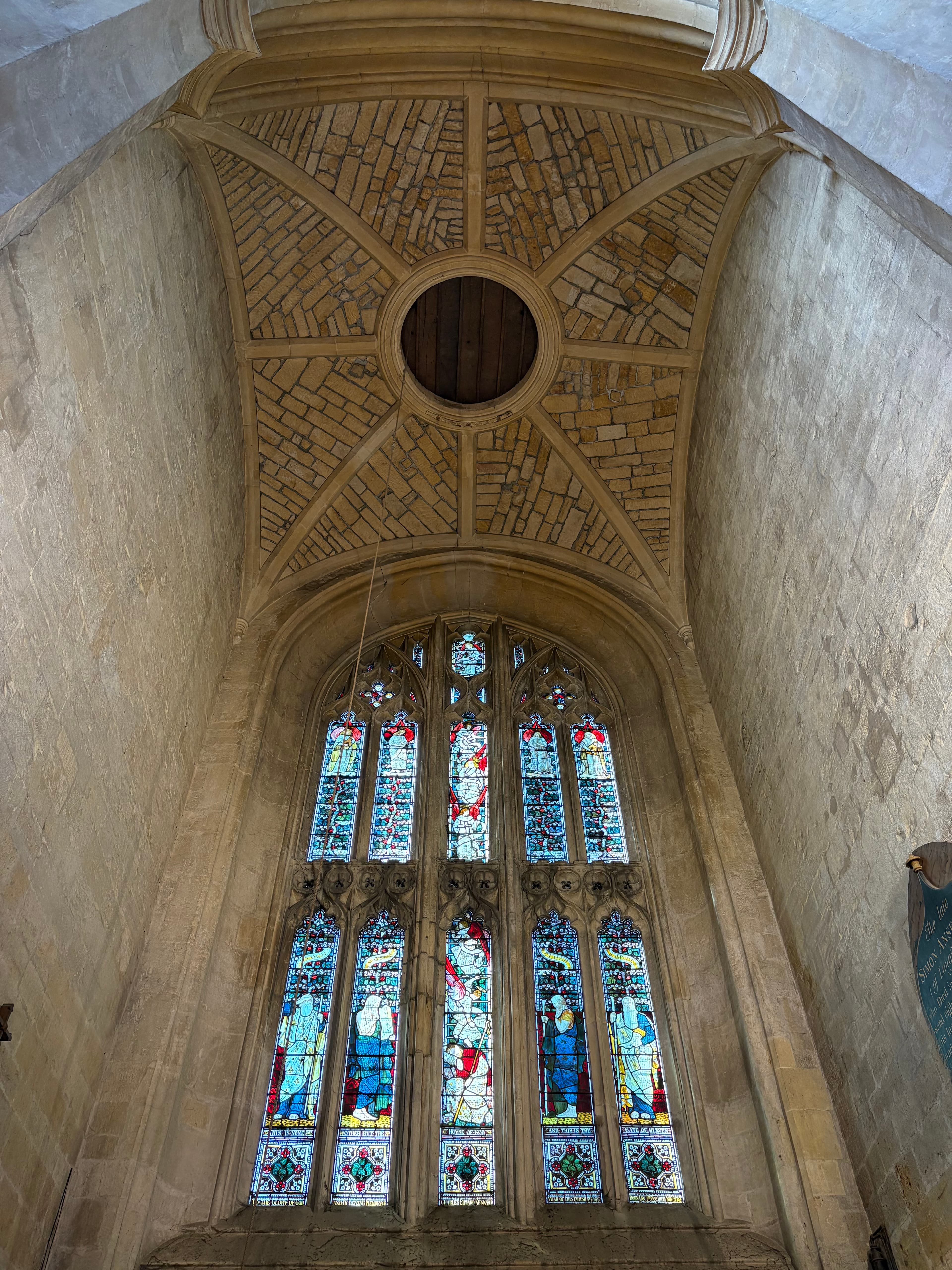 Stone vaulting above a side window at St James's, with a five-light Perpendicular window beneath