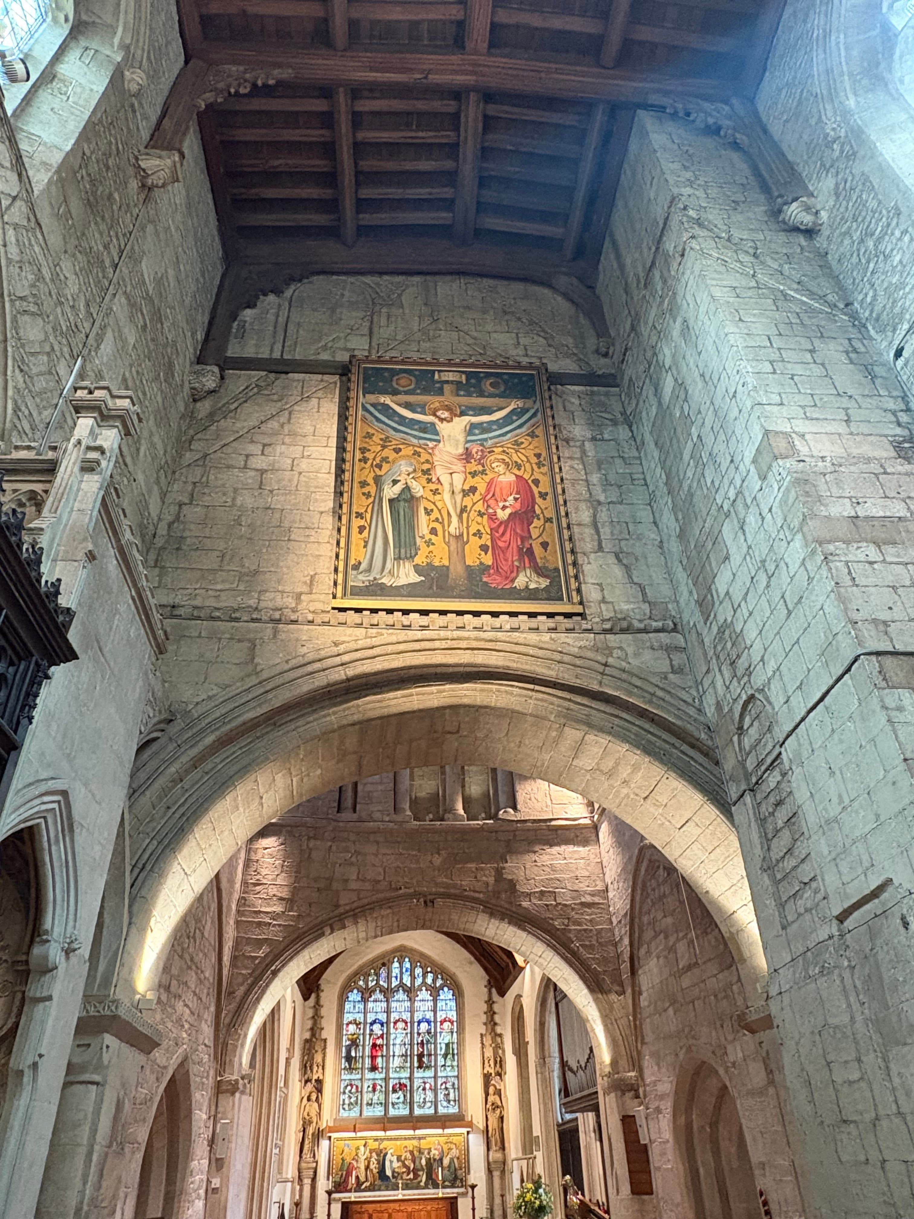 An interior arch with a painted panel of a saint set into the wall