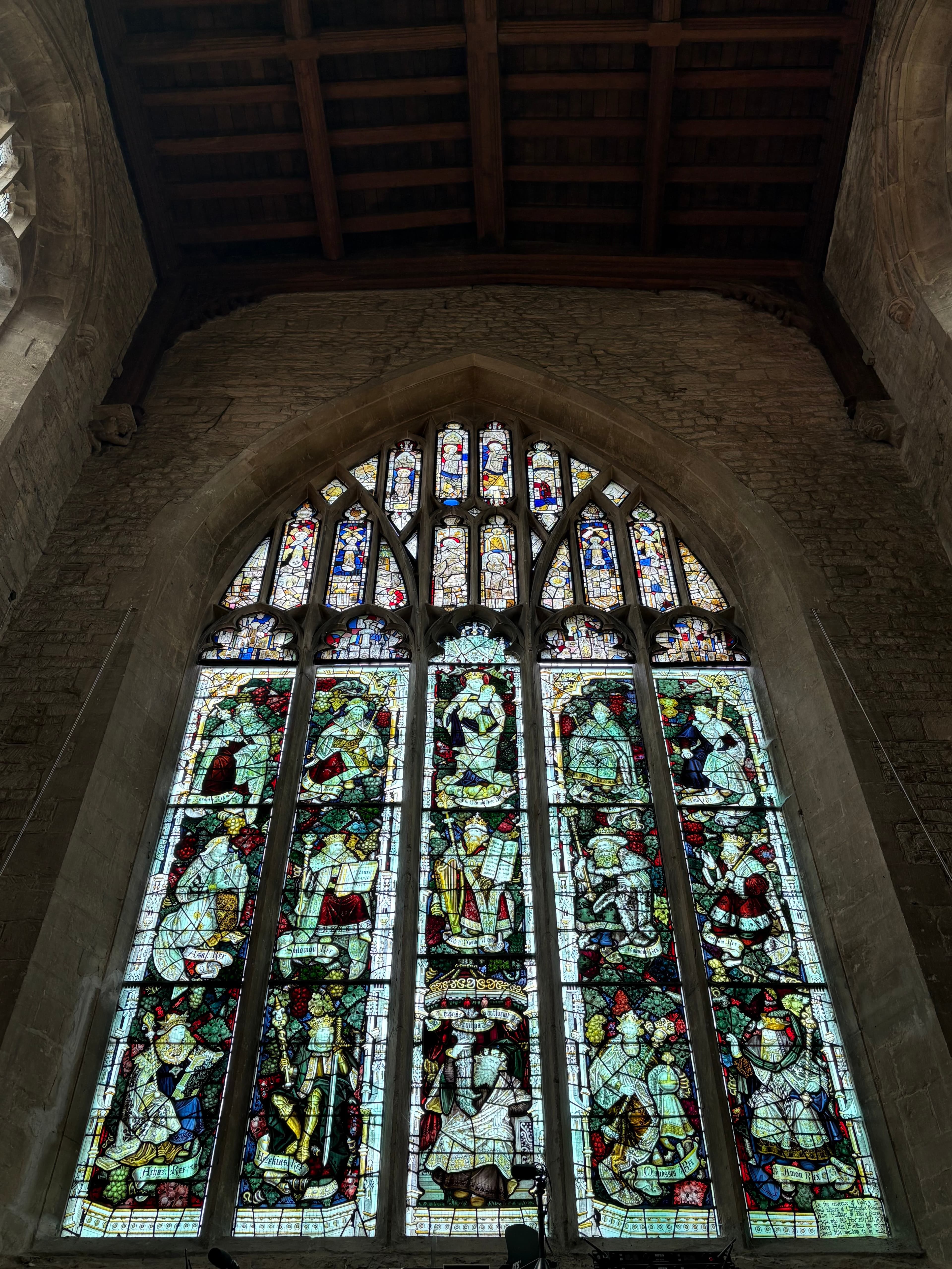 A tall lancet stained-glass window in mid-20th-century style