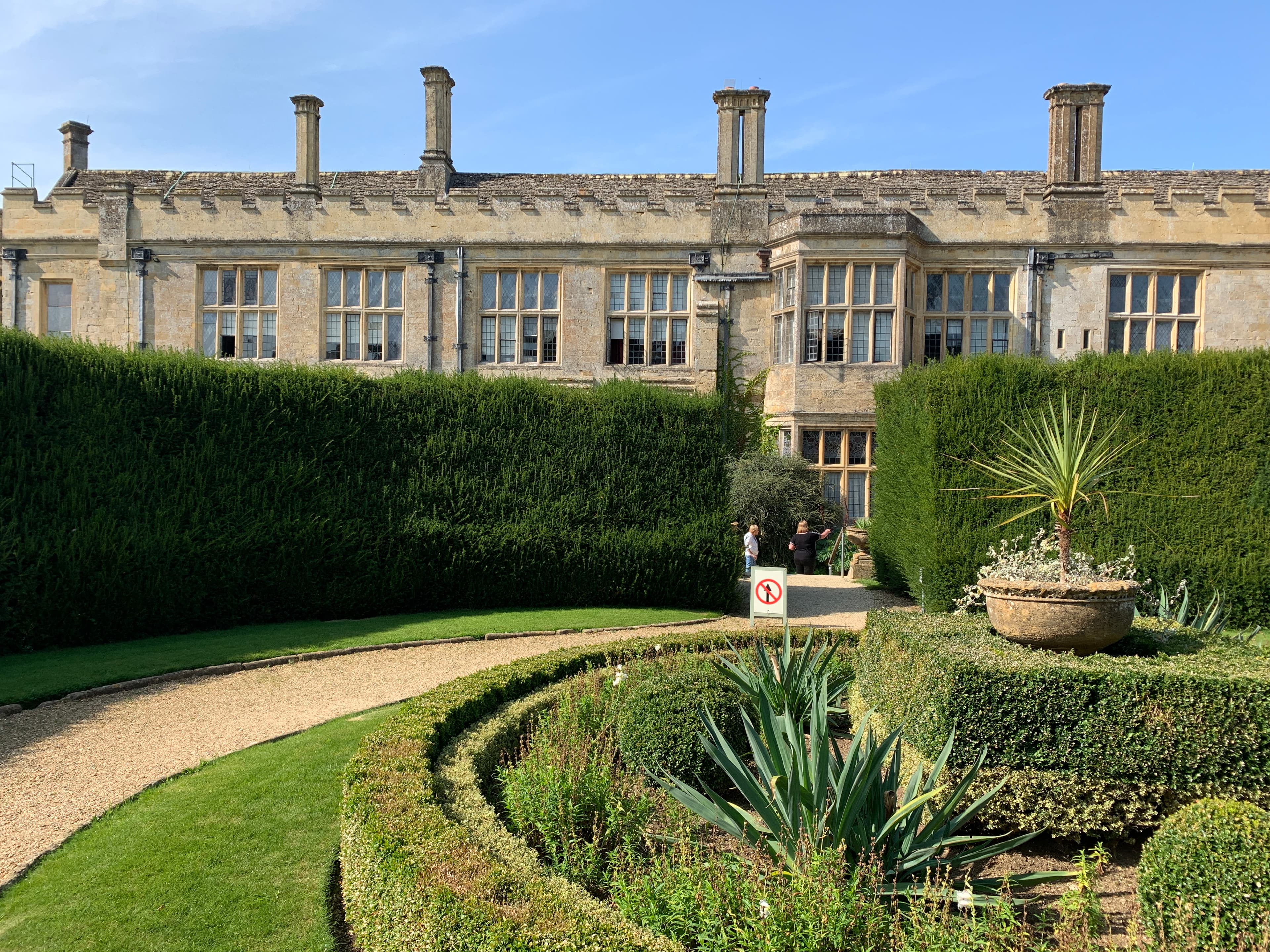 The chimneys, mullioned windows and bay-windowed range of Sudeley's south facade, seen from the formal parterre