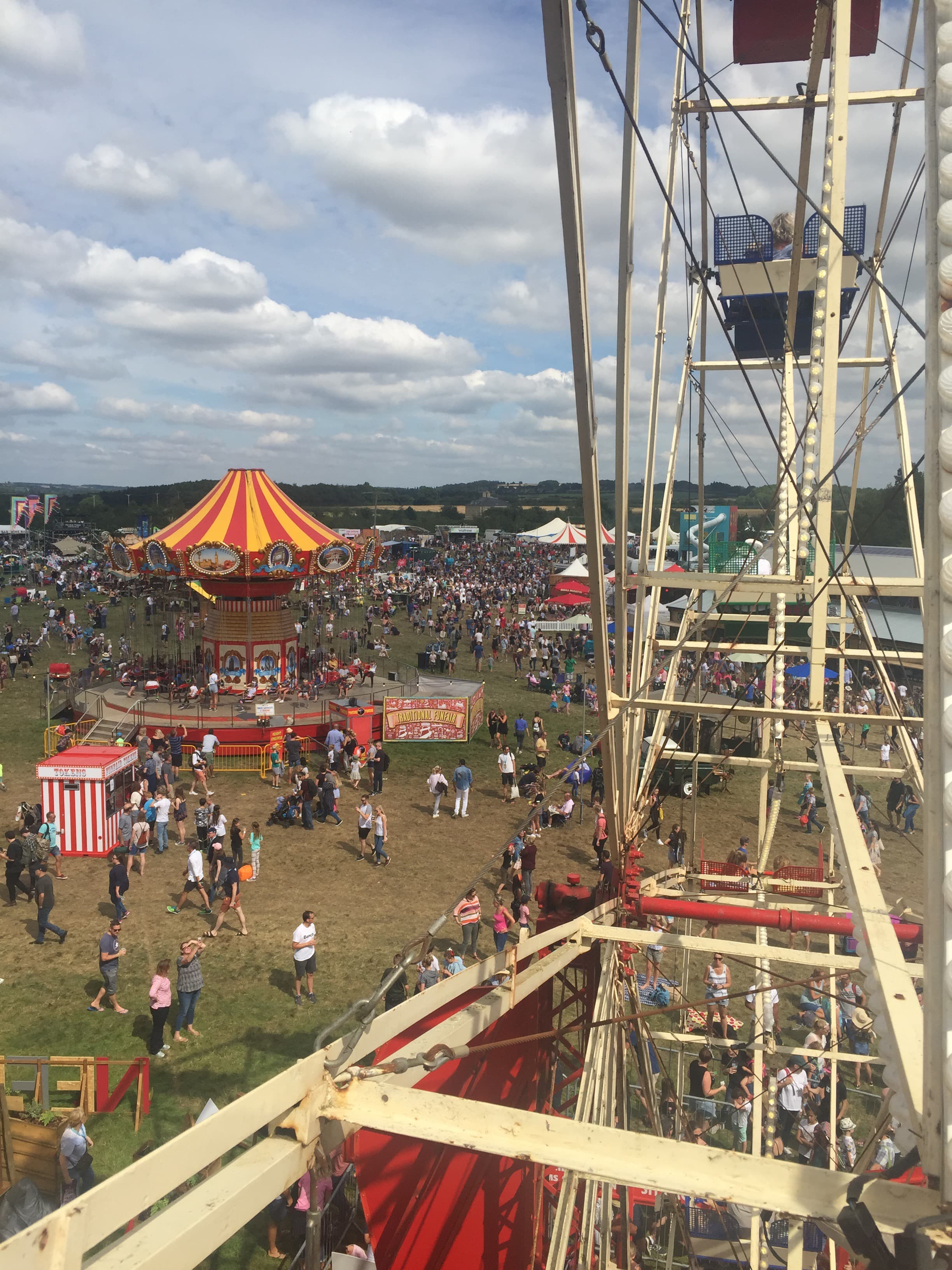 View from inside the Big Feastival's ferris wheel looking down on the crowds and a striped circus tent