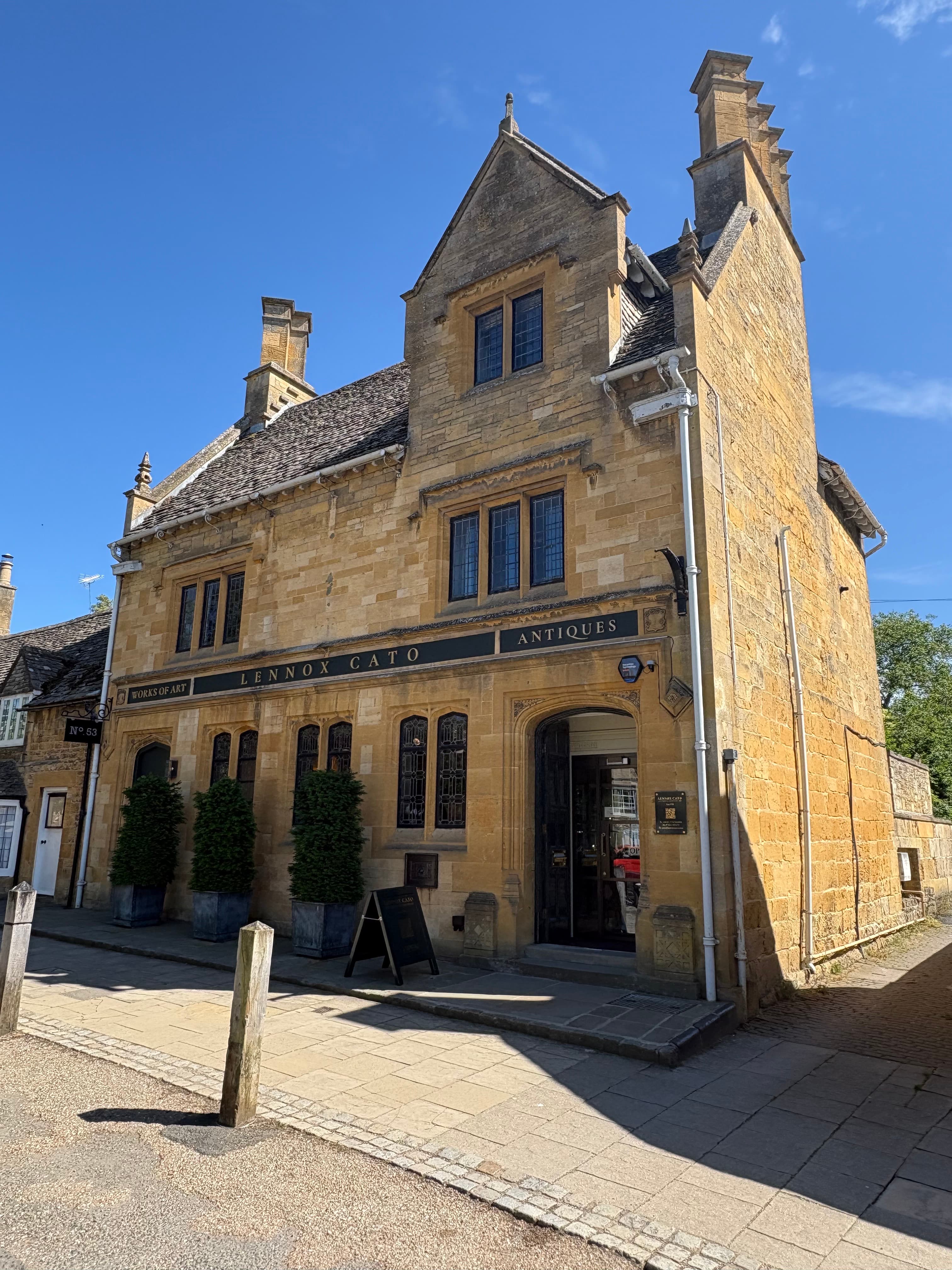 The Lygon Arms Antiques shop — a gabled Cotswold-stone building on the high street
