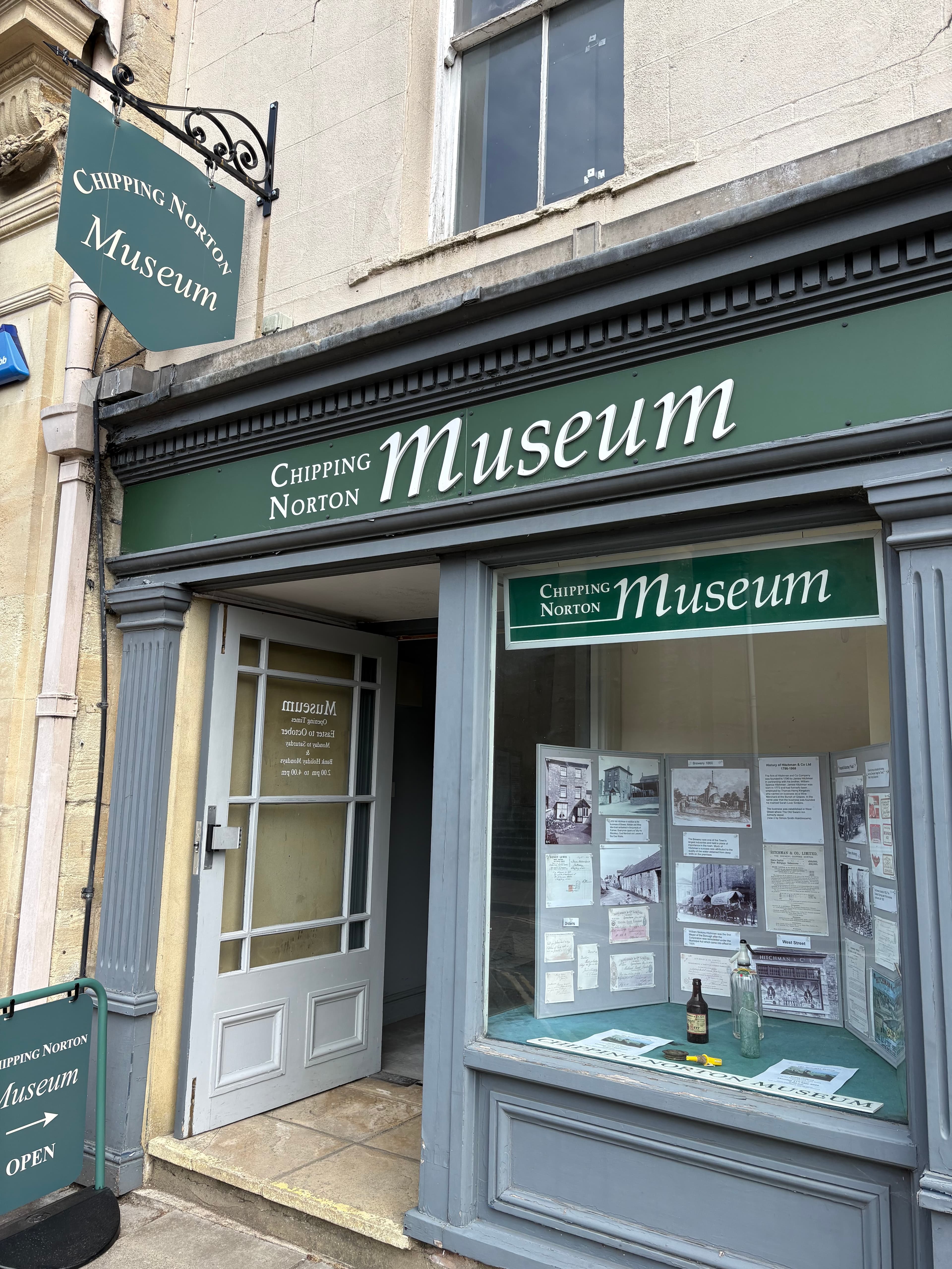 The green-and-cream sign of the Chipping Norton Museum on the high street