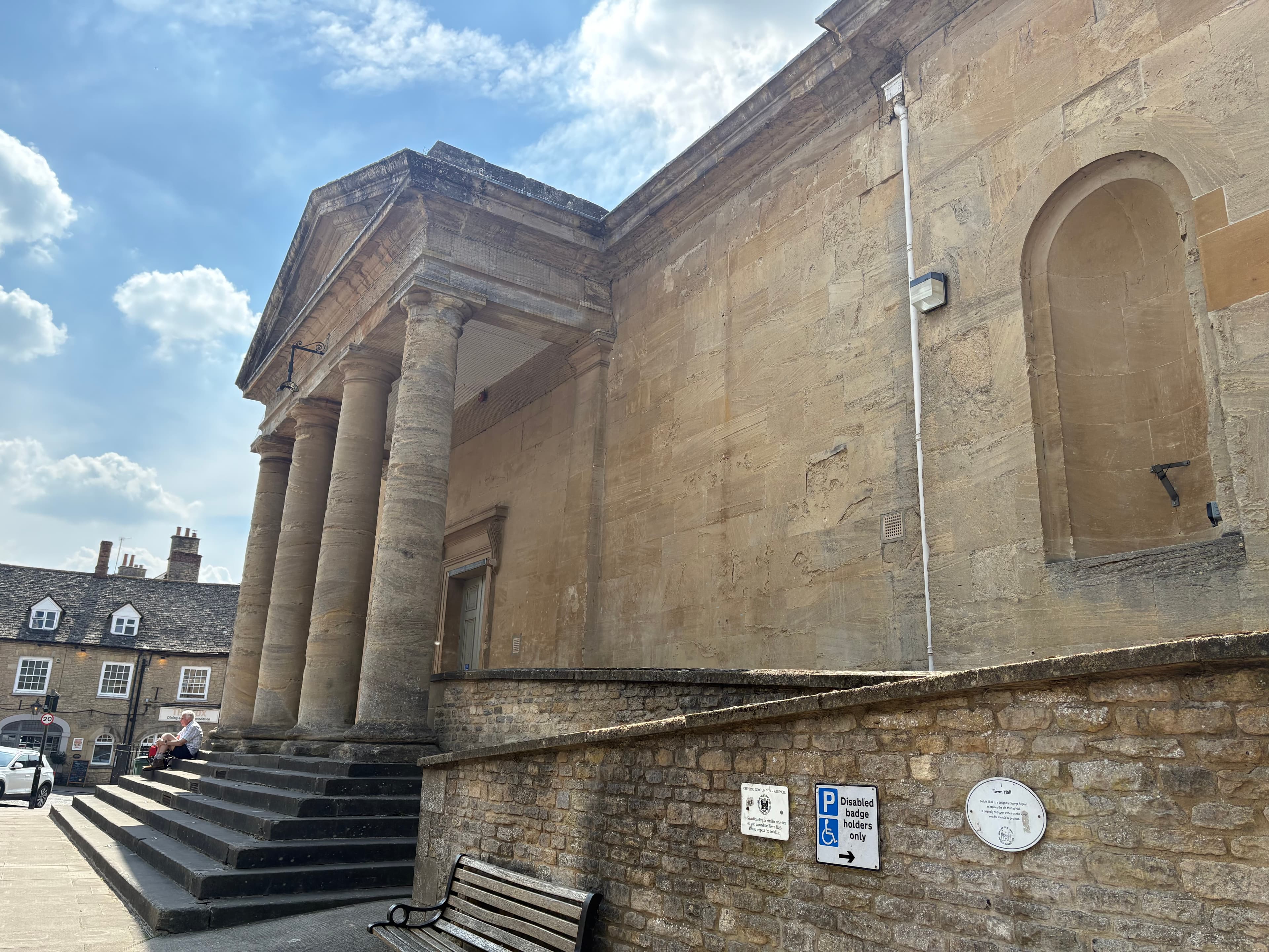 The 1842 Town Hall on Chipping Norton's Market Place — a Greek-revival classical portico of fluted columns and pediment