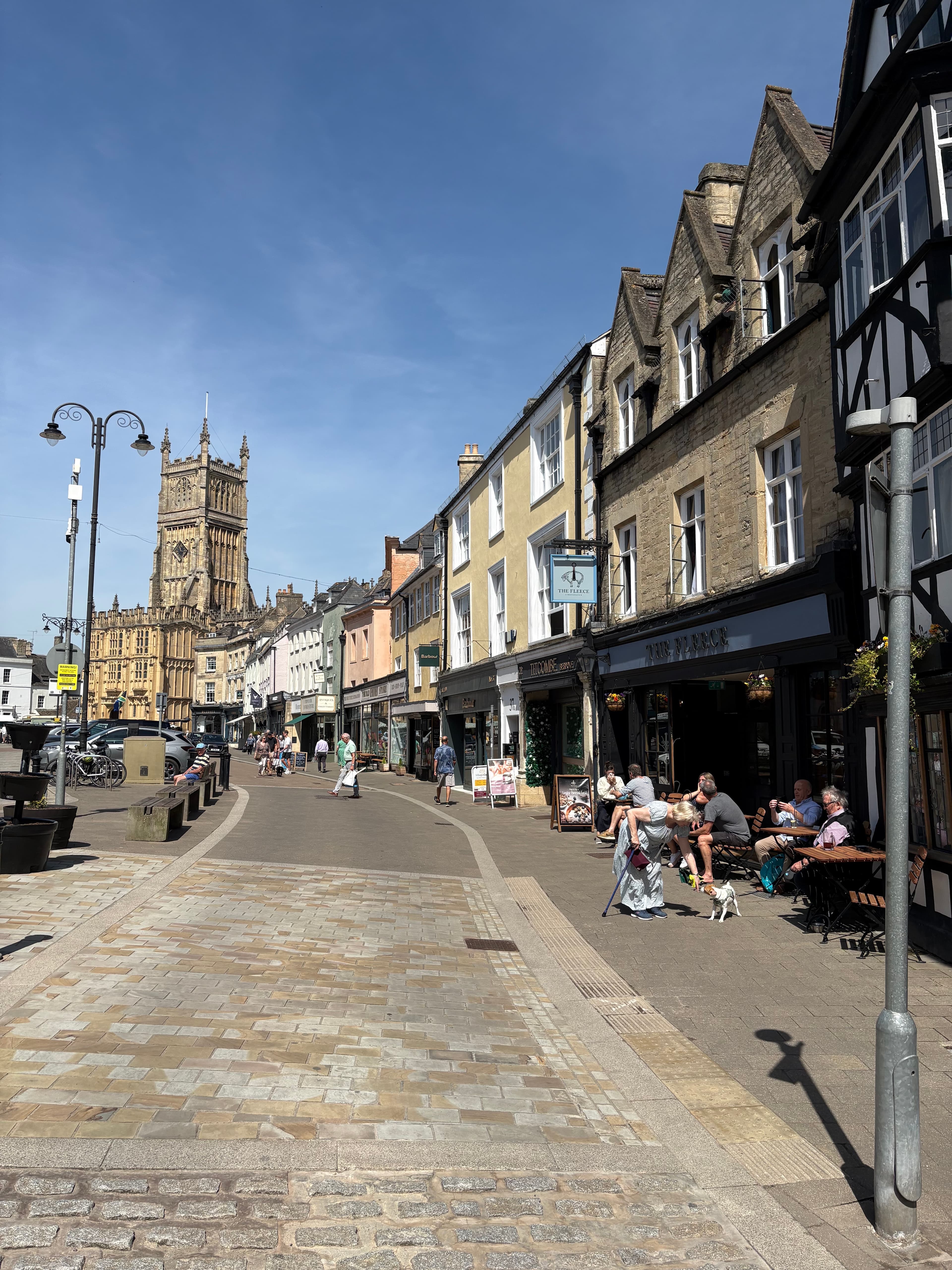 A cafe terrace on the Market Place, with the spire of St John the Baptist in the background