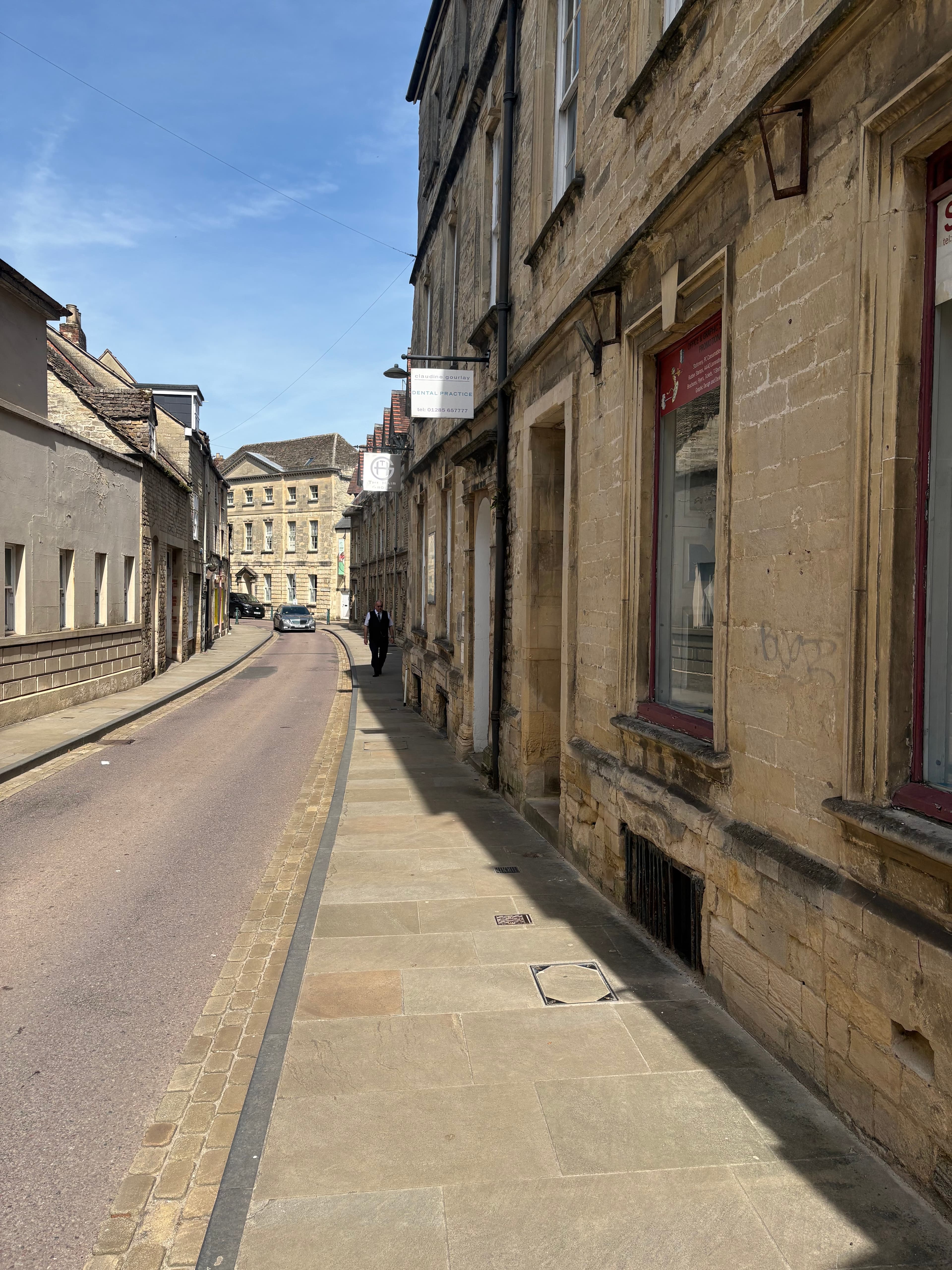A stone arched colonnade running along the high street pavement
