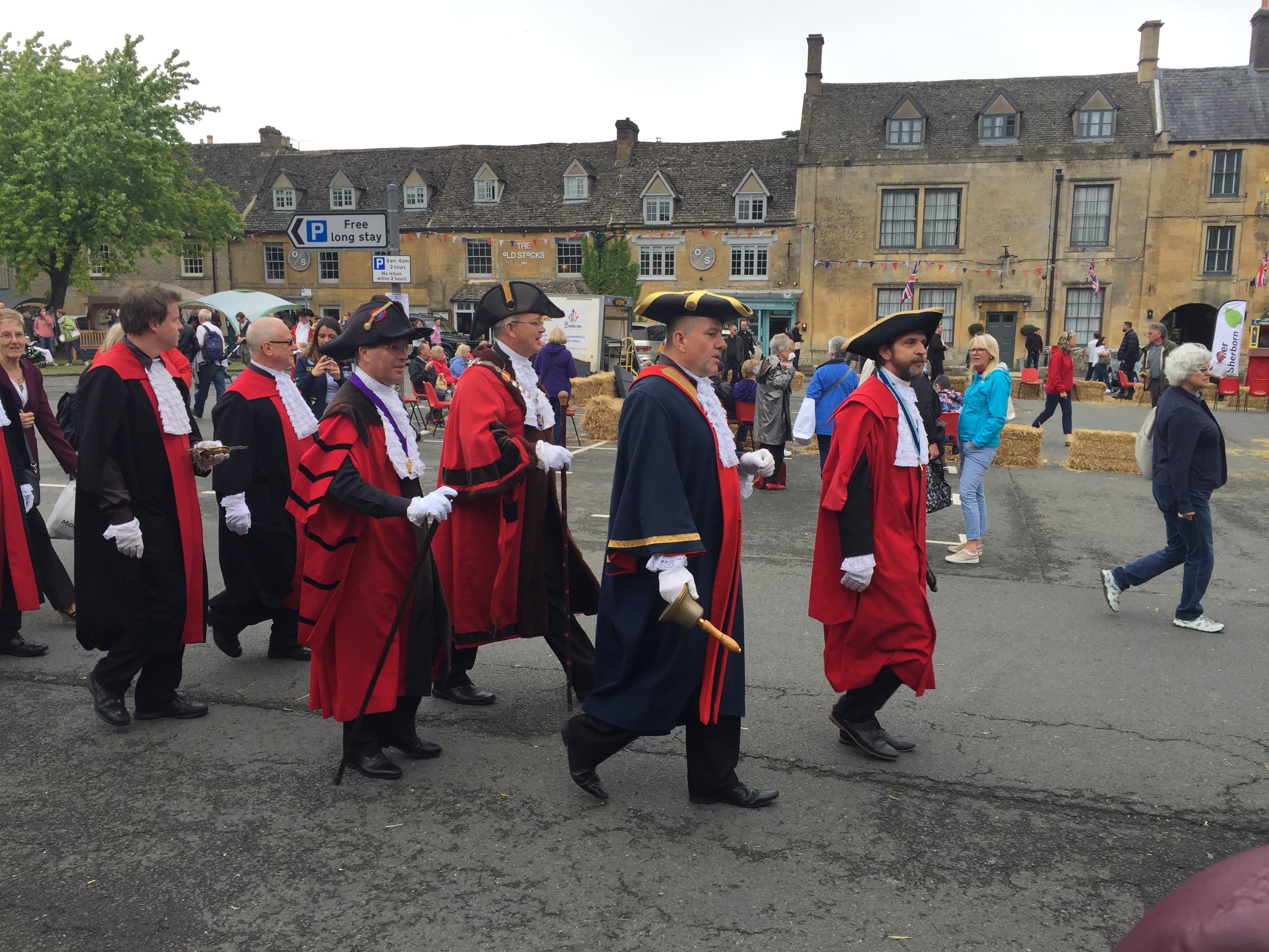The Mayor of Stow and councillors in ceremonial red robes and tricorn hats process across the Market Square, with a bellman leading the way