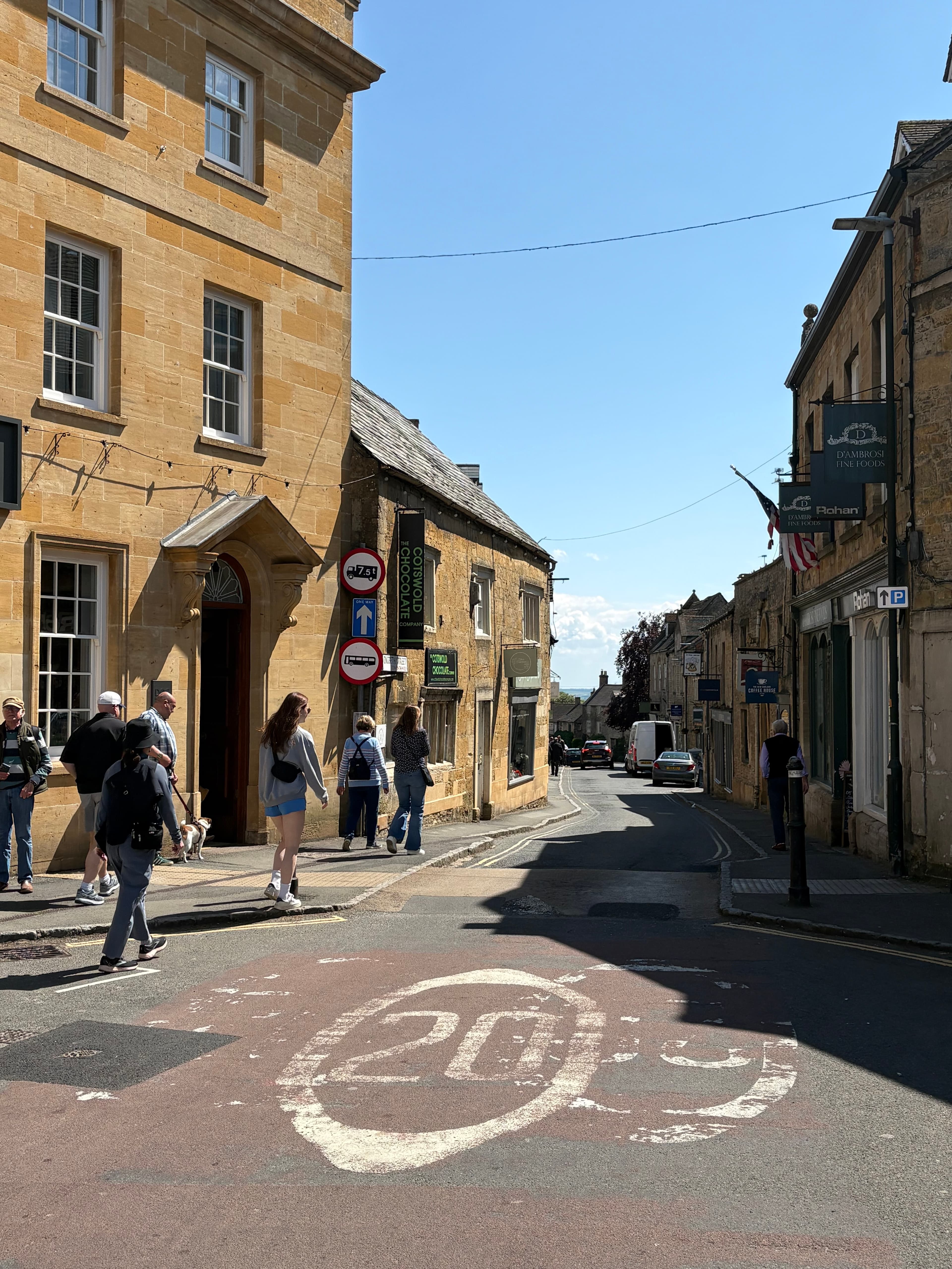 Visitors on Stow's High Street, with the painted 20mph marker on the road